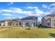 Expansive backyard with manicured lawn, screened porch, patio, and landscaping, offering a serene outdoor retreat at 2217 Holtwood Way, Apex, NC 27523