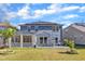 Inviting backyard featuring a screened porch, patio, and well-maintained lawn, perfect for outdoor living and entertaining at 2217 Holtwood Way, Apex, NC 27523
