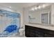 Bathroom with double sink vanity, granite countertop, framed mirror, and shower with blue curtain at 2217 Holtwood Way, Apex, NC 27523