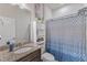 Bathroom featuring granite vanity, a modern shower curtain, and a built-in storage cabinet at 2217 Holtwood Way, Apex, NC 27523