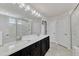 Bathroom featuring a double sink vanity, a large mirror, and a shower at 2217 Holtwood Way, Apex, NC 27523