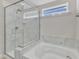 Bathroom featuring a separate shower stall with glass door and a soaking tub at 2217 Holtwood Way, Apex, NC 27523