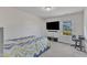Bright bedroom featuring a flat-screen TV, a keyboard, and a cozy, patterned bedspread at 2217 Holtwood Way, Apex, NC 27523