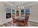 Bright dining room with a wood table, elegant chandelier, and natural light from large windows overlooking the backyard at 2217 Holtwood Way, Apex, NC 27523