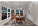 Cozy dining room with round table, four chairs, natural light, and backyard views at 2217 Holtwood Way, Apex, NC 27523