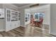 Dining room with white built-in cabinet and view to backyard through large windows at 2217 Holtwood Way, Apex, NC 27523