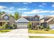 Charming two-story home with stone accents, red shutters, landscaped yard, and a two-car garage at 2217 Holtwood Way, Apex, NC 27523