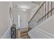 Inviting foyer with hardwood floors, staircase, white wainscoting, and a white front door at 2217 Holtwood Way, Apex, NC 27523