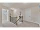Upstairs hallway featuring neutral walls, carpet, white doors, and open access to rooms at 2217 Holtwood Way, Apex, NC 27523