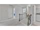 Upstairs hallway with white doors, wooden banister and carpeted floor at 2217 Holtwood Way, Apex, NC 27523
