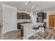 Modern kitchen with dark cabinets, granite countertops, stainless steel appliances, and a spacious center island at 2217 Holtwood Way, Apex, NC 27523