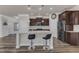 Bright kitchen featuring dark cabinets, stainless steel appliances, and center island with seating at 2217 Holtwood Way, Apex, NC 27523
