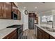 Well-appointed kitchen with stainless steel appliances, granite countertops, and dark wood cabinetry at 2217 Holtwood Way, Apex, NC 27523
