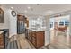 Contemporary kitchen with island, stainless steel appliances, dark wood cabinets, and open layout to dining area at 2217 Holtwood Way, Apex, NC 27523