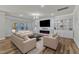 Bright living room features built-in shelving, modern fireplace, hardwood floors, and comfortable seating at 2217 Holtwood Way, Apex, NC 27523