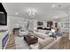 Open-concept living room featuring modern decor, hardwood floors, and seamless transition to the kitchen at 2217 Holtwood Way, Apex, NC 27523