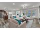 Open-concept living room featuring modern decor, hardwood floors, and seamless transition to the kitchen at 2217 Holtwood Way, Apex, NC 27523