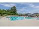 Community pool area with multiple lounge chairs, umbrellas, and clear blue water, perfect for relaxation and recreation at 2217 Holtwood Way, Apex, NC 27523