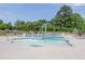 Inviting community pool with a splash fountain feature, lounge chairs, and umbrellas, ideal for Gathering fun and relaxation at 2217 Holtwood Way, Apex, NC 27523