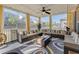 Spacious covered porch with comfortable seating, a ceiling fan, and decorative pillows and accents throughout at 2217 Holtwood Way, Apex, NC 27523