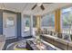 Well-decorated covered porch with cozy seating, sheer curtains, and a ceiling fan for outdoor enjoyment at 2217 Holtwood Way, Apex, NC 27523