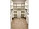 Organized walk-in closet with built-in shelving and drawers providing ample storage at 2217 Holtwood Way, Apex, NC 27523