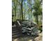 Backyard deck with stairs surrounded by a lush backyard with a blooming white azalea bush at 2603 Red Pine Rd, Hillsborough, NC 27278