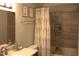 Modern bathroom featuring a shower-tub combo with decorative gray tile and sleek hardware at 2603 Red Pine Rd, Hillsborough, NC 27278