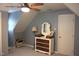 Attic bedroom with sloped walls, featuring a stylish dresser and a ceiling fan at 2603 Red Pine Rd, Hillsborough, NC 27278