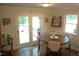 Bright dining area with a wooden table, four chairs, and access to an outdoor deck at 2603 Red Pine Rd, Hillsborough, NC 27278