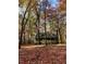 Beautiful home surrounded by trees during fall with the leaves changing colors at 2603 Red Pine Rd, Hillsborough, NC 27278
