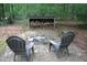Fire pit sitting area with Adirondack chairs on brick patio at 2603 Red Pine Rd, Hillsborough, NC 27278