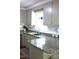 Modern kitchen with granite countertops, stainless steel sink, and white subway tile backsplash at 2603 Red Pine Rd, Hillsborough, NC 27278