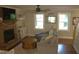Cozy living room featuring a brick fireplace, plush seating, and natural light from two windows at 2603 Red Pine Rd, Hillsborough, NC 27278