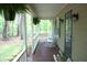 Welcoming front porch with rocking chairs, hanging ferns, and a dark stained wood floor at 2603 Red Pine Rd, Hillsborough, NC 27278
