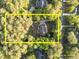 Aerial view of a property surrounded by lush greenery, showing estimated property lines at 2616 Dockery Ln, Raleigh, NC 27606