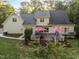 Aerial view of backyard featuring a large deck with outdoor seating and mature trees at 2616 Dockery Ln, Raleigh, NC 27606