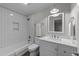 This stylish bathroom has a shower over bath, white tiles, and modern vanity at 2616 Dockery Ln, Raleigh, NC 27606