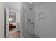 This bathroom has white tiles, a modern shower and bedroom in view at 2616 Dockery Ln, Raleigh, NC 27606