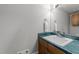 Small half bathroom with a white sink, green marble counters, and wood vanity at 2616 Dockery Ln, Raleigh, NC 27606