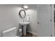 This bathroom features white porcelain pedestal sink, toilet and tiled floor at 2616 Dockery Ln, Raleigh, NC 27606