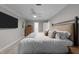 This spacious bedroom features a ceiling fan, natural light, and a large bed at 2616 Dockery Ln, Raleigh, NC 27606