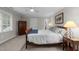 This bedroom features natural light, wooden furniture, and neutral walls at 2616 Dockery Ln, Raleigh, NC 27606