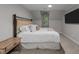 Bedroom with a large bed, neutral carpet, and a decorative window in the slanted wall at 2616 Dockery Ln, Raleigh, NC 27606
