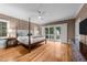 Spacious bedroom features a four-poster bed, hardwood floors, and access to a private balcony at 2616 Dockery Ln, Raleigh, NC 27606