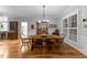 Charming dining room with hardwood floors, a wooden table, and a view of the kitchen at 2616 Dockery Ln, Raleigh, NC 27606