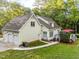 Exterior view showcasing the home's well-maintained yard, three-car garage and rear deck at 2616 Dockery Ln, Raleigh, NC 27606