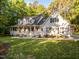 Charming two-story home featuring a large front porch, well-maintained lawn, and lush landscaping at 2616 Dockery Ln, Raleigh, NC 27606
