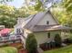 Rear exterior view of a home with a spacious deck and a well-maintained landscaped yard at 2616 Dockery Ln, Raleigh, NC 27606
