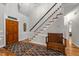 Welcoming foyer with hardwood floors, staircase, and stylish decor at 2616 Dockery Ln, Raleigh, NC 27606